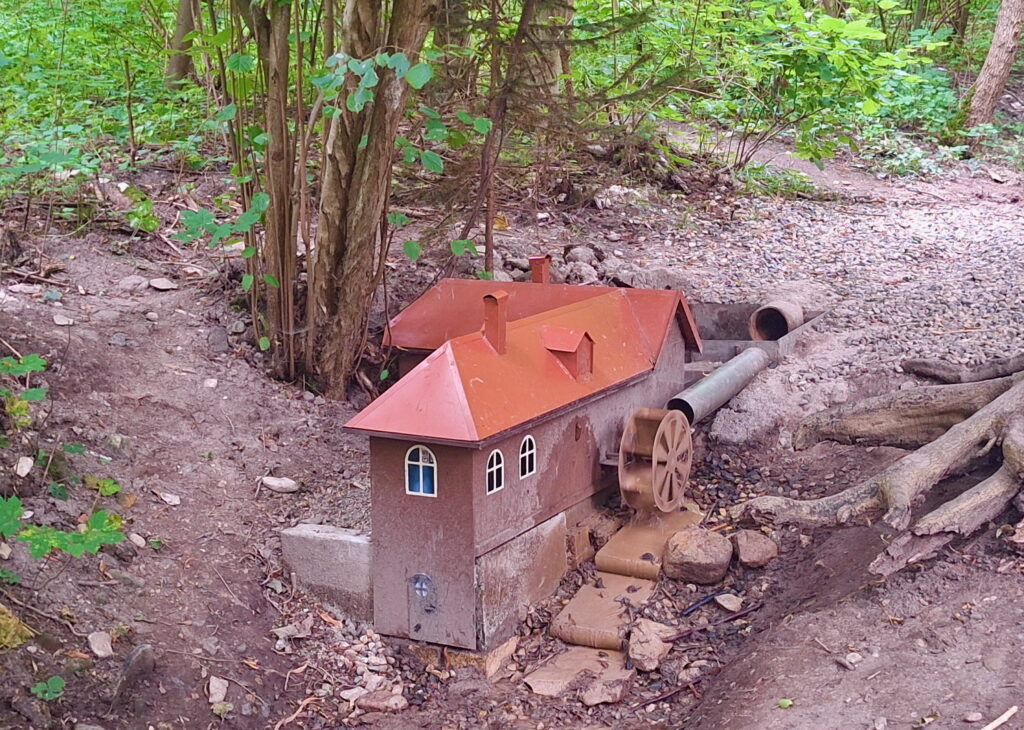 Tiny water mill in the forest.
